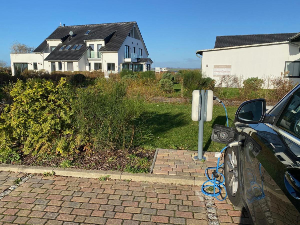 Moenchgut Living & Spa Gager Exterior photo A car is charged at a charging station in Germany